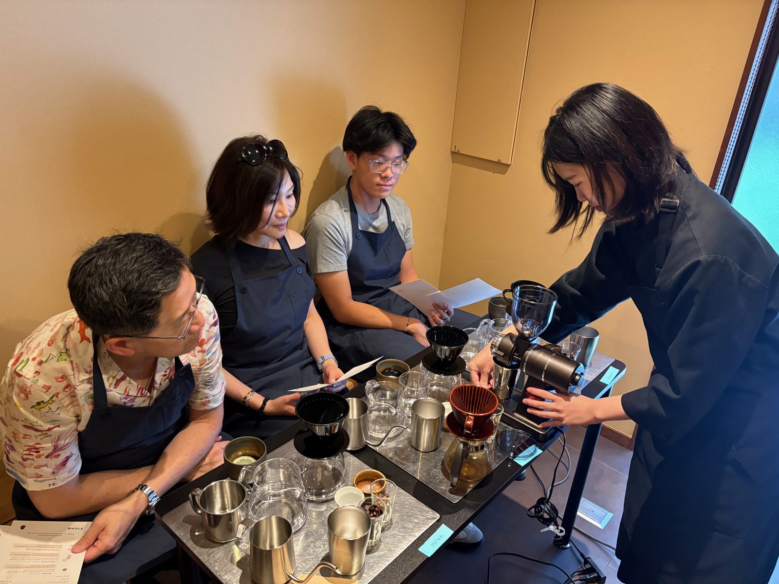 The Master demonstrating the coffee grinder at each guest's station